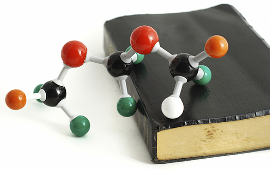 Science and Faith. Bible and chemical molecular model