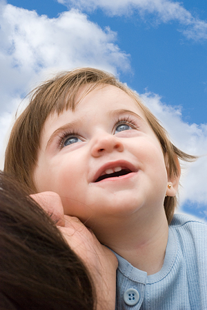 Smiling girl with mother looking upwards