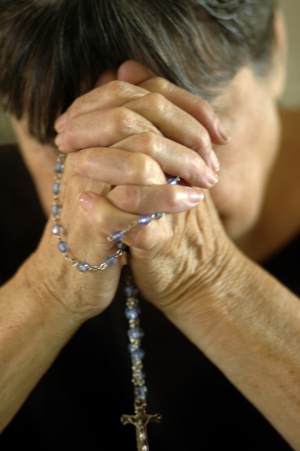 Elder woman in deep prayer